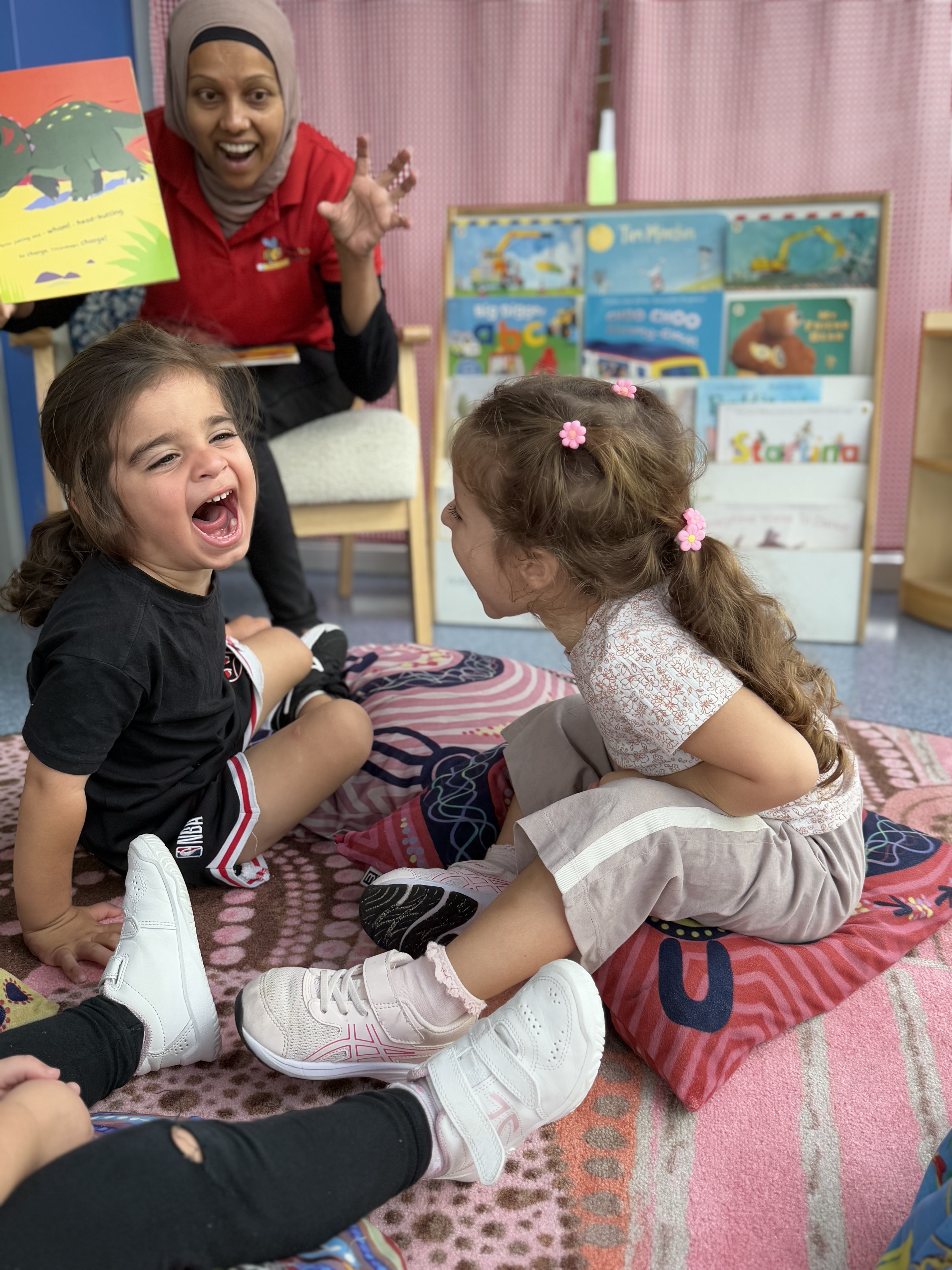 Toddler engaging in play-based learning with educator at Bumblebee Academy